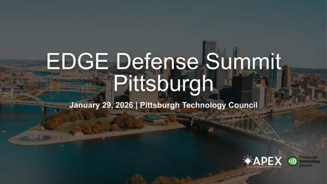 Aerial photo of the Pittsburgh skyline with skyscrapers, bridges, and a river running across.